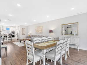 Dining room with wood finished floors, recessed lighting, and baseboards