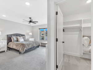 Bedroom featuring light colored carpet, recessed lighting, baseboards, and ceiling fan