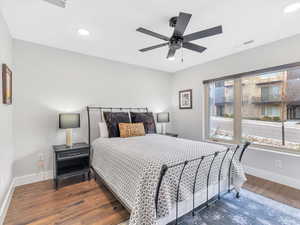 Bedroom with wood finished floors, baseboards, recessed lighting, and a ceiling fan