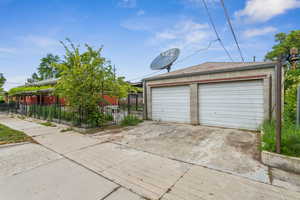 Detached garage featuring fence