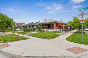 Bungalow-style home with a front lawn and brick siding