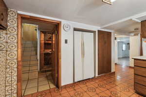 Hallway with light tile patterned floors