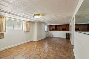 Unfurnished living room with baseboards