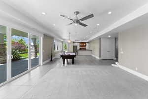 Playroom featuring light tile patterned flooring, recessed lighting, billiards table, bar area, and a ceiling fan