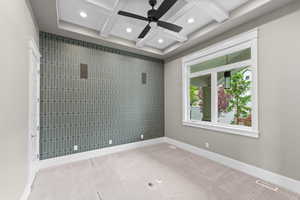 Carpeted empty room with coffered ceiling, beam ceiling, recessed lighting, and ceiling fan