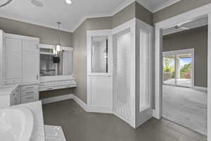 Full bathroom with ornamental molding, tiled tub, baseboards, recessed lighting, and tile patterned floors