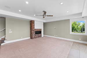 Unfurnished living room featuring recessed lighting, a ceiling fan, a fireplace, stairway, and baseboards