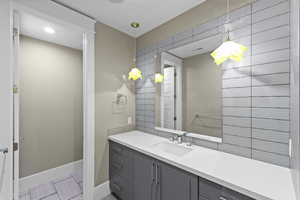Bathroom featuring baseboards and vanity