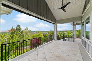 View of patio featuring a ceiling fan and a balcony