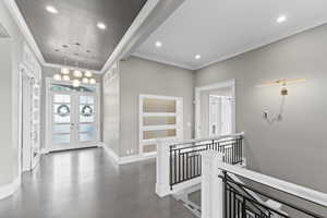 Entryway featuring french doors, ornamental molding, dark wood-style floors, and recessed lighting