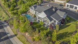 Aerial view of property and surrounding area with a pool area