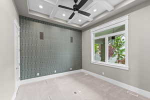 Carpeted spare room featuring coffered ceiling, ceiling fan, recessed lighting, baseboards, and beamed ceiling