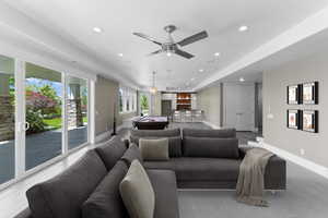 Living area featuring recessed lighting, bar area, and ceiling fan