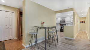 Dining space featuring light wood-style floors, baseboards, and recessed lighting