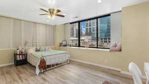Bedroom with wood finished floors, recessed lighting, baseboards, and ceiling fan