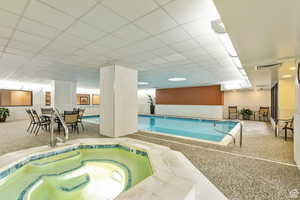 View of indoor community pool and spa