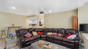 Living room featuring light wood-style flooring, recessed lighting, and baseboards