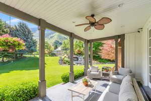 View of patio featuring a mountain view, outdoor lounge area, and a ceiling fan