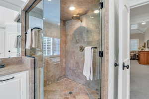Full bath featuring ornamental molding, a stall shower, and vanity