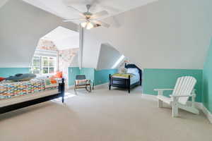 Bedroom with baseboards, carpet floors, vaulted ceiling, and a ceiling fan