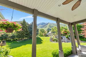 View of grassy yard with a mountain view