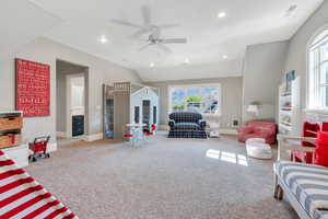 Living room with a ceiling fan, carpet floors, baseboards, recessed lighting, and lofted ceiling