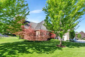 View of home's exterior with a lawn and stone siding