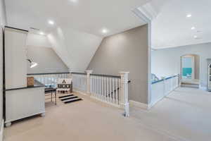 Hall featuring carpet flooring, an upstairs landing, recessed lighting, baseboards, and arched walkways