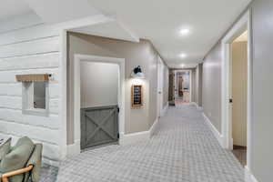 Hall featuring carpet, baseboards, and recessed lighting
