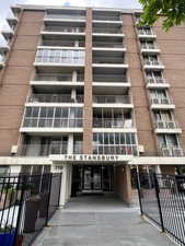 View of apartment building / complex featuring fence