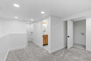 Finished below grade area with carpet, baseboards, and recessed lighting