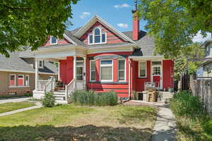 Victorian house featuring a porch and a chimney