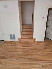 Stairs featuring wood finished floors and baseboards