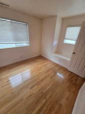Spare room featuring light wood-type flooring and baseboards