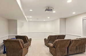 Home theater room with recessed lighting, ceiling-mounted projector, carpet flooring, and baseboards