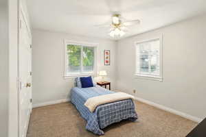 Bedroom featuring carpet flooring, baseboards, and ceiling fan