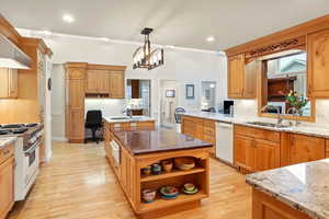 Kitchen featuring range with gas stovetop, dishwasher, a sink, a warming drawer, and a desk