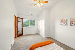 Bedroom featuring carpet flooring, baseboards, a ceiling fan, and vaulted ceiling