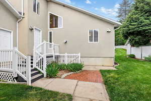 View of side of home featuring stucco siding, entrance to garage, mudroom, and basement ADU