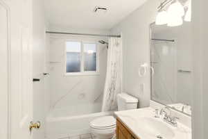 ADU full bathroom featuring toilet, shower / bath combination with curtain, vanity, and tile patterned floors