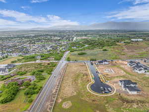 View of property location with a mountain backdrop and nearby suburban area