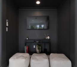 Sitting room featuring recessed lighting and a decorative wall