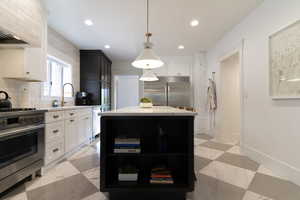 Kitchen featuring appliances with stainless steel finishes, open shelves, tasteful backsplash, white cabinetry, and recessed lighting