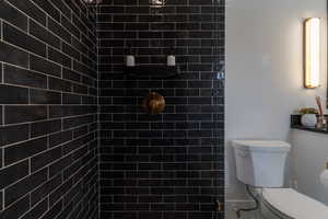 Bathroom with toilet and a tile shower