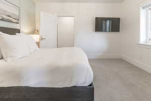 Bedroom featuring carpet flooring and baseboards