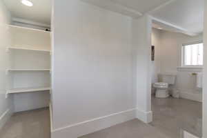 Bathroom featuring toilet and baseboards