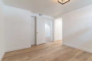 Unfurnished room featuring baseboards and light wood-type flooring
