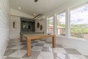 Playroom featuring a wall mounted AC, vaulted ceiling, recessed lighting, and baseboards