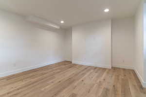 Empty room featuring recessed lighting, light wood finished floors, and baseboards