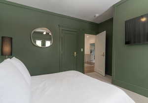 Bedroom featuring carpet and baseboards
